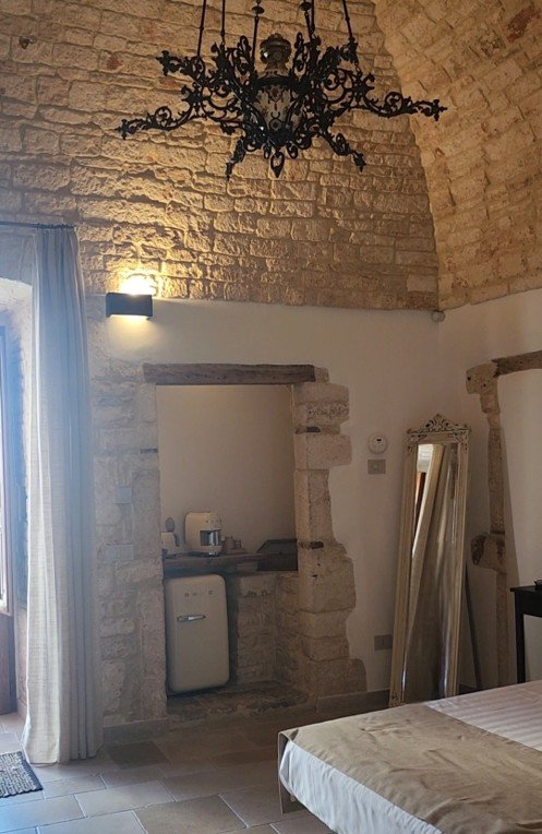 Traditional trullo bedroom with stone walls and old-world details