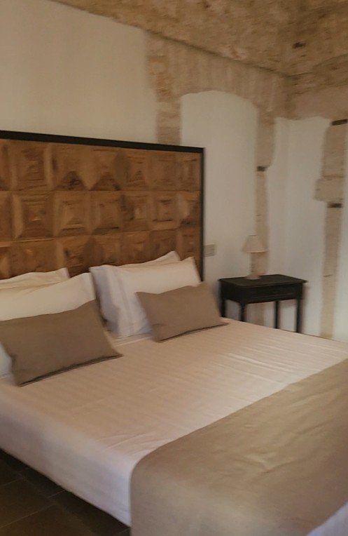 Traditional trullo double bed and wall detail in Alberobello
